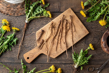 Fresh Dandelion Roots On A Wooden Cutting Board, Top View