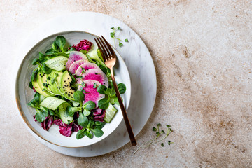 Wall Mural - Mix fresh leaves salad with lamb's lettuce, avocado, cucumber, watermelon radish, seeds and sprouts. Overhead view, copy space