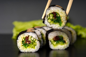 Wall Mural - stuffed sushi on a dark background