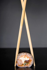 Wall Mural - sushi and sushi sticks on a dark background