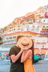 Summer holiday in Italy. Young couple in Positano village on the background, Amalfi Coast, Italy