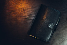 Directly Above Shot Of Closed Leather Diary On Table