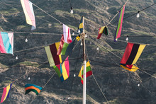 Various Flags Against Mountain