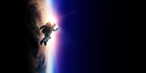 Wall Mural - spaceman and planet, human in space concept