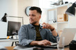 © JustLife - Businessman in office. Handsome man working on lap top.