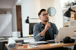 © JustLife - Businessman in office. Handsome man working on lap top.
