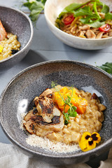 Canvas Print - Risotto with white mushrooms and pumpkin in gray bowl