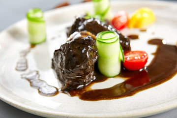 Canvas Print - Veal cheeks with smoky honey mushrooms and squash in beige plate