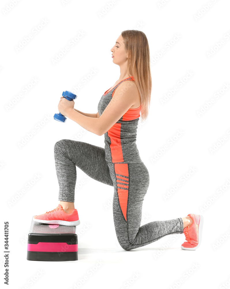 Sporty young woman training with dumbbells on white background
