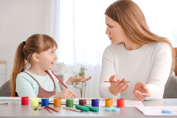 Wall Mural - Drawing teacher giving private art lessons to little girl at home