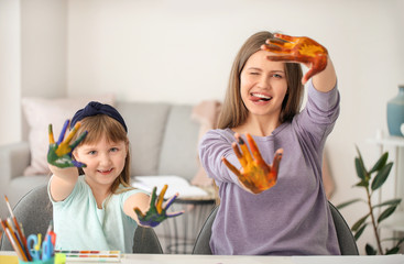 Wall Mural - Drawing teacher giving private art lessons to little girl at home