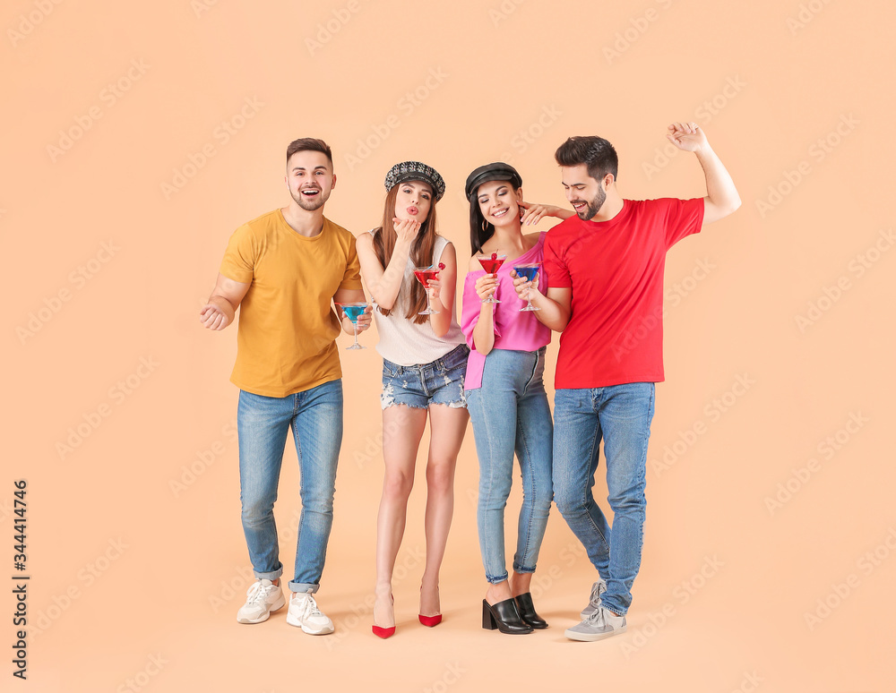 Happy young people with cocktails on color background