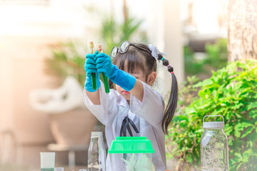 Close-up background view of a cute girl Who are learning science, business concepts, experimenting with chemical coloring or marketing planning