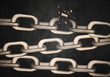 © New Africa - Broken metal chains on black background. Freedom concept
