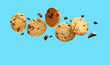 Chocolate chip cookies flying over aqua blue background. Copy space