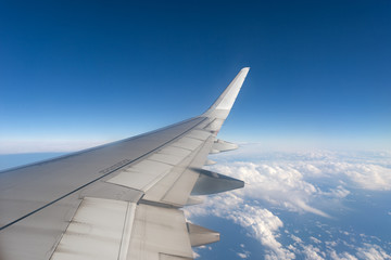 Wall Mural - Airplane wings while flying in the sky