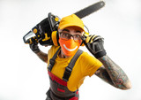 Fototapeta Do pokoju - a guy in protective coveralls with a chainsaw on a white background