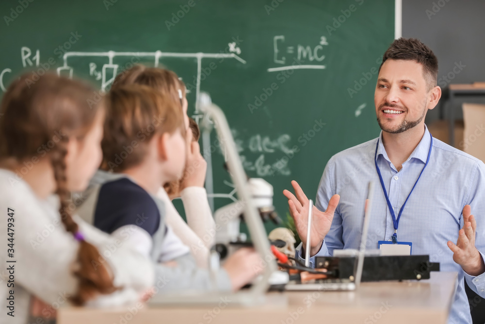 Teacher conducting physics lesson in classroom