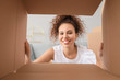 © Pixel-Shot - Happy woman with open box, view from inside