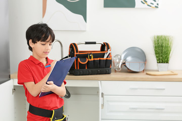 Poster - Portrait of little plumber in kitchen