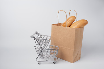 paper bag for shopping in the shopping cart, isolated on a white background.Concept of business, retail, sales and online Commerce