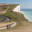 Bicycle Tour of the South Downs. A view over the south coast landscape towards Beachy Head and its lighthouse. East Sussex, England, UK.