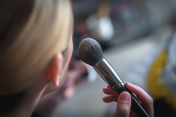 The makeup brush and girl's face 