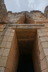 Wall Mural - Mycenae, Greece: The entrance to the Treasury of Atreus, or Tomb of Agamemnon, constructed during the Bronze Age around 1250 BC.