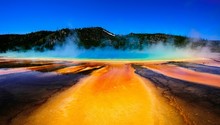 Idyllic Shot Of Hot Spring And Smoke At Yellowstone National Park Against Sky