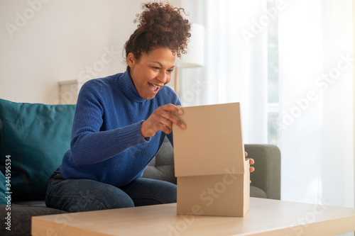 Cuadros en Lienzo Happy black woman unboxing just delivered item after home shopping