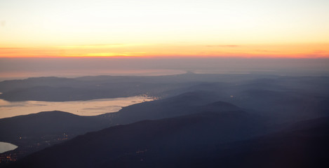 Wall Mural - Sunset landscape view of the coast from the plane.