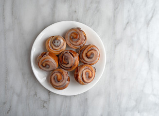 Wall Mural - Bite size cinnamon swirl rolls on a white plate