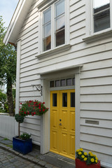 Wall Mural - Yellow door of white town wooden house, Norway,