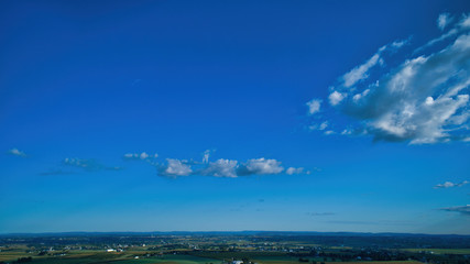 Wall Mural - Blue sky and multiple clouds background showing a horizon