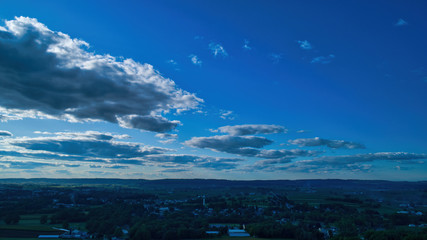 Wall Mural - Blue sky and multiple clouds background showing a horizon