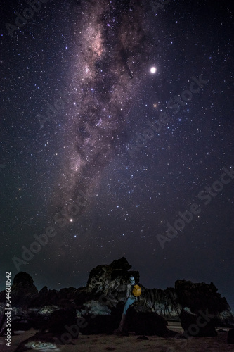 Cuadros en Lienzo Person enjoys amazing magical milky way galaxy night sky nearby rock formations