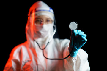 Women doctor wearing protective suit with stethoscope mask check health condition.