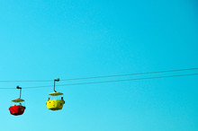 Low Angle View Of Overhead Cable Cars Against Clear Blue Sky