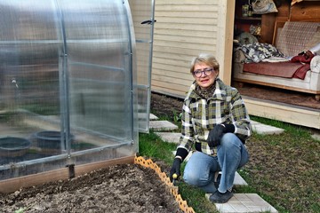 coronavirus. the woman is isolated at home. engaged in the garden and vegetable garden. there is alw