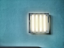 Illuminated Light Fixture On Turquoise Wall