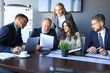 © ty - Group of business partners discussing ideas and planning work in office.