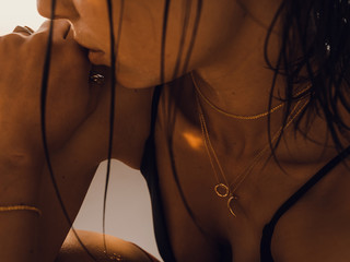 Tender jewerly on female neck, photoshoot in the studio