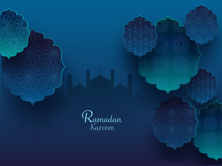 Wall Mural - Islamic holy month of prayers concept with exquisite floral pattern and mosque silhouette on teal blue background.