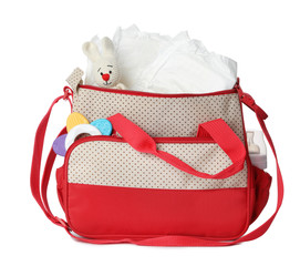 Wall Mural - maternity bag with disposable diapers and child's accessories on white background