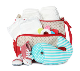 Wall Mural - Maternity bag with disposable diapers and child's accessories on white background