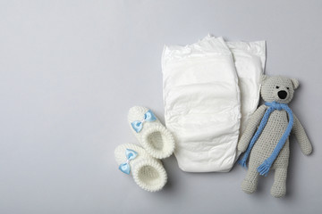 Wall Mural - diapers and baby accessories on light grey background, flat lay. space for text