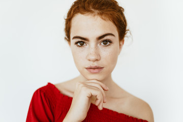 the beautiful face of a young girl with a raised, surprised eyebrow looking at the camera with beautiful expressive eyes