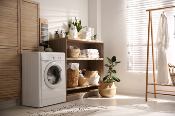 Poster - Modern washing machine and shelving unit in laundry room interior