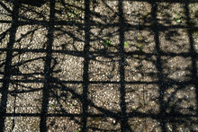 Shadow Of A Chain Weight On The Ground