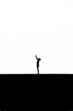 Silhouette Woman Practicing Yoga Against White Background